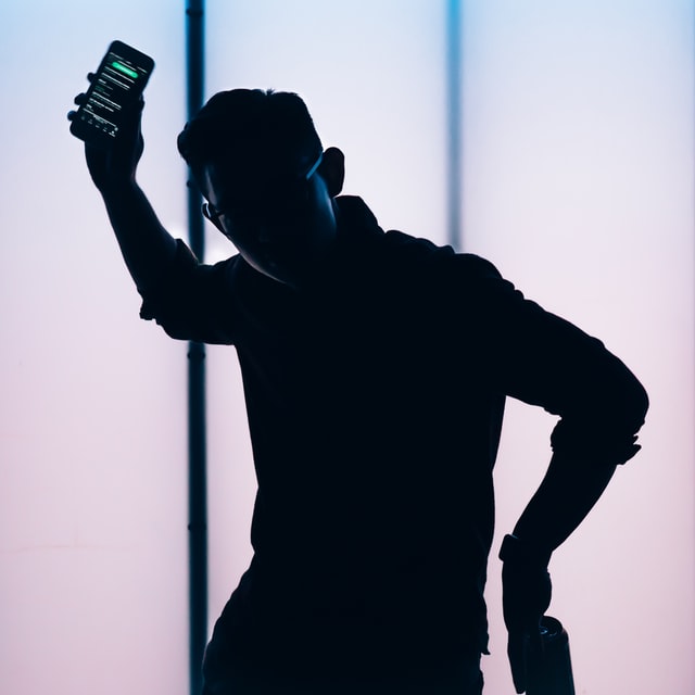 picture of a man with phone in dark